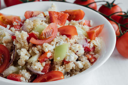 healthy vegetarian quinoa salad with pepper and tomatoesの写真素材