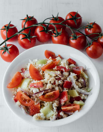 healthy vegetarian quinoa salad with pepper and tomatoesの写真素材