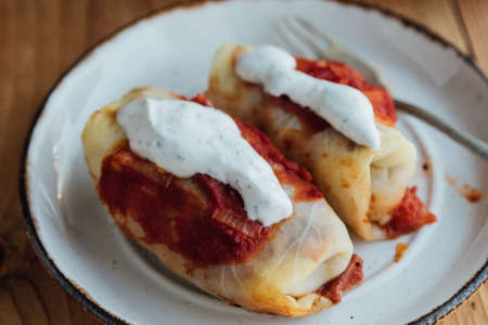 Stuffed cabbage rolls with meat and rice served with tomato sauceの写真素材
