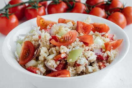 healthy vegetarian quinoa salad with pepper and tomatoesの写真素材