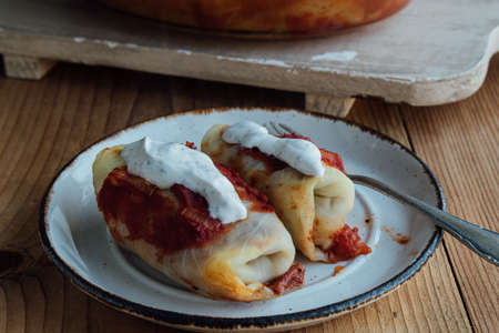 Stuffed cabbage rolls with meat and rice served with tomato sauceの写真素材