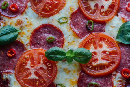 fresh tasty rustic salami pizza closeup shotの写真素材