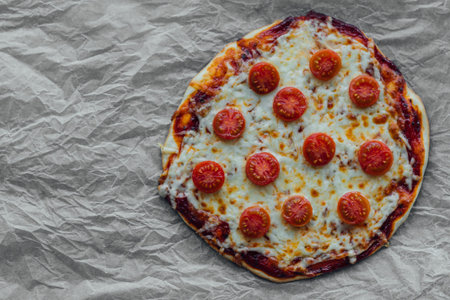 top view of a fresh rustic margherita pizza on baking paper