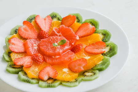 healthy fruit plate with kiwi orange strawberry and grapefruitの写真素材