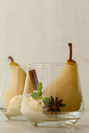 delicious poached pears in glass with ice creamの写真素材