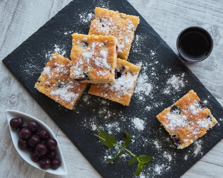 fresh tassty cherry fruit sponge cake with sugarの写真素材