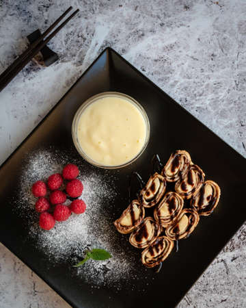 banan pancake sushi dessert with dip and chocolate syrupの写真素材