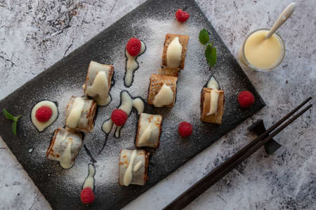 banan pancake sushi dessert with dip and chocolate syrupの写真素材