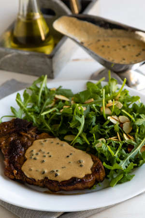 steak with arugula and green peppercorn sauceの写真素材