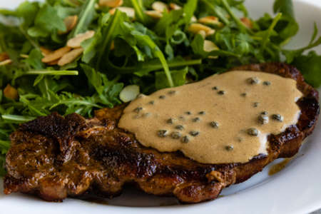 steak with arugula and green peppercorn sauceの写真素材