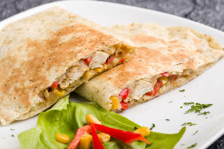 tasty fresh quesadilla with chicken meat and vegetablesの写真素材
