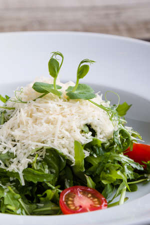 fresh tasty healthy rucola salad in white plateの写真素材
