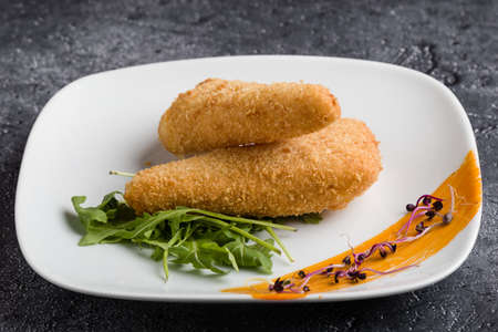 tasty fresh fried breaded cheese on white palteの写真素材