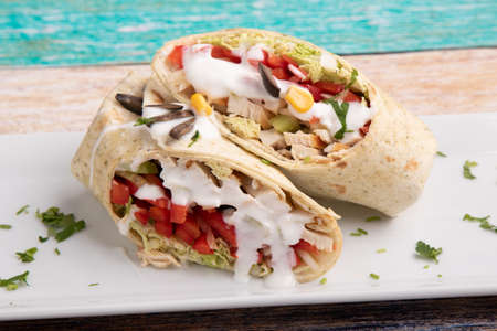 tasty wrap with chicken meat and greensの写真素材