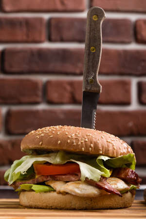 tasty rustic hamburger with fries on wooden tableの写真素材