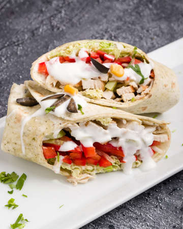 tasty wrap with chicken meat and greensの写真素材