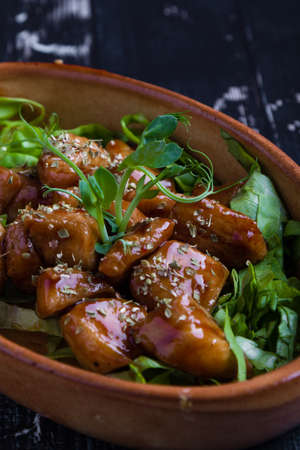 small tasty fresh chicken bites in a rustic bowlの写真素材