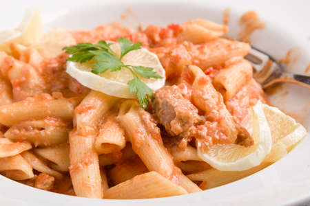 tasty penne with tuna pasta on white plateの写真素材