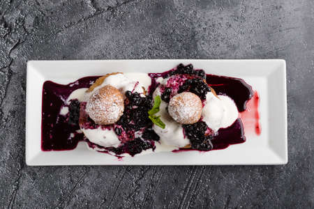 fresh delicious cottage cheese donuts with jam on white plateの写真素材
