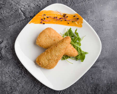 tasty fresh fried breaded cheese on white palteの写真素材