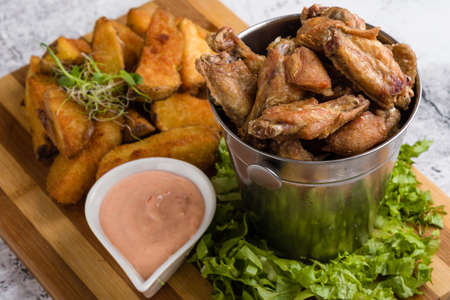 fried chicken wings with potato and dipping sauceの写真素材