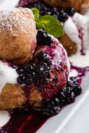 fresh delicious cottage cheese donuts with jam on white plateの写真素材