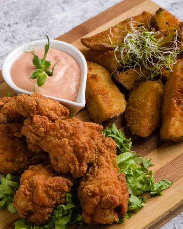 deep fried crispy chicken with fries and dipping sauceの写真素材