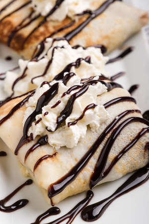 european pancakes, sweet crepe with topping on white long plateの写真素材