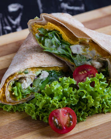 tasty wrap with chicken meat and greensの写真素材