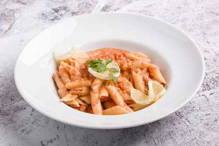 tasty penne with tuna pasta on white plateの写真素材