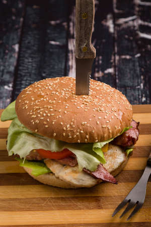 tasty rustic hamburger with fries on wooden tableの写真素材