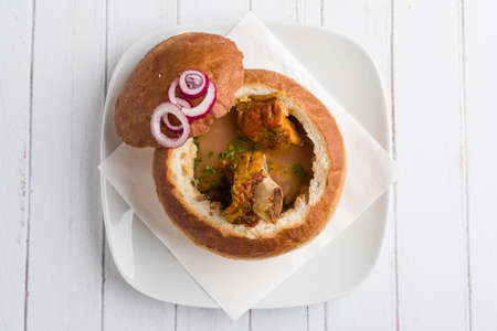 tasty delicious bean soup with smoked meat in breadの写真素材