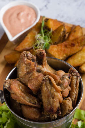 fried chicken wings with potato and dipping sauceの写真素材