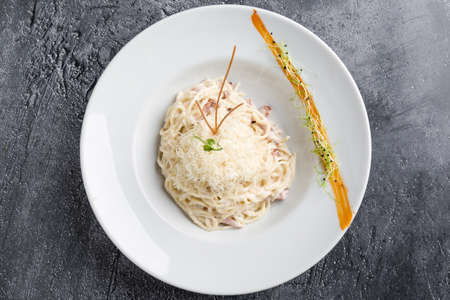 italian spahetti carbonara pasta in white plateの写真素材