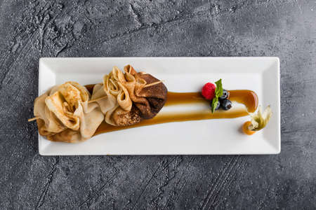 european pancakes, sweet crepe with topping on white long plateの写真素材