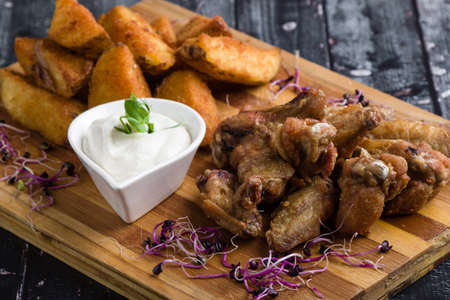 fried chicken wings with potato and dipping sauceの写真素材