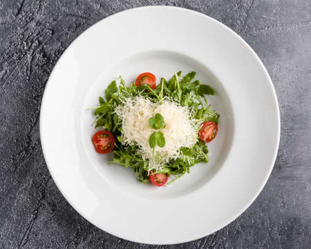 fresh tasty healthy rucola salad in white plateの写真素材