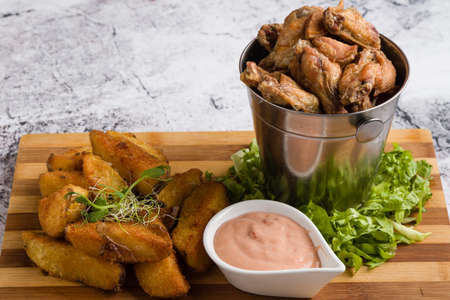 fried chicken wings with potato and dipping sauceの写真素材