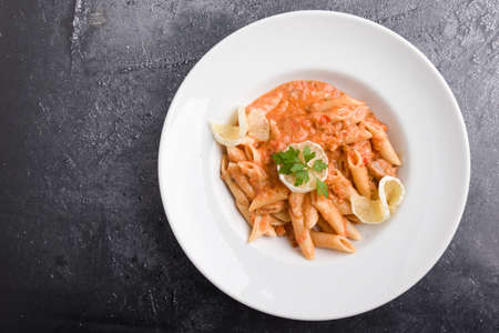 tasty penne with tuna pasta on white plateの写真素材