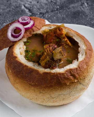 tasty delicious bean soup with smoked meat in breadの写真素材