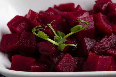 fresh tasty beetroot salad with greens in white bowlの写真素材