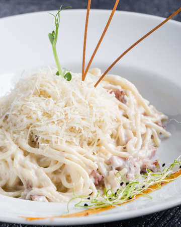 italian spahetti carbonara pasta in white plateの写真素材