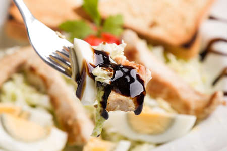fresh tasty caesar salad appetizer in white plateの写真素材