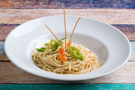 fresh spaghetti olio peperoncini pasta in white plateの写真素材