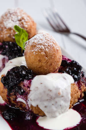 fresh delicious cottage cheese donuts with jam on white plateの写真素材
