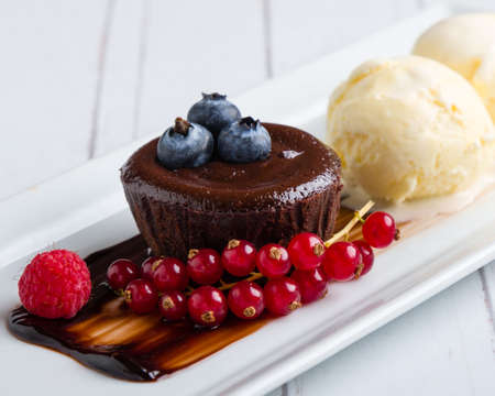 lava cake with ice cream and fruits on white plateの写真素材