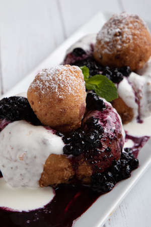fresh delicious cottage cheese donuts with jam on white plateの写真素材