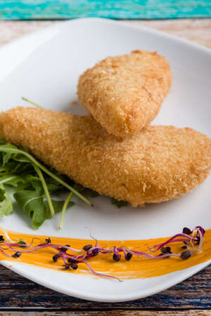 tasty fresh fried breaded cheese on white palteの写真素材