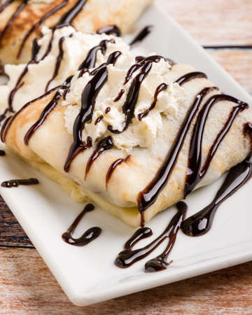 european pancakes, sweet crepe with topping on white long plateの写真素材