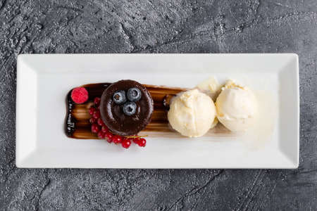 lava cake with ice cream and fruits on white plateの写真素材